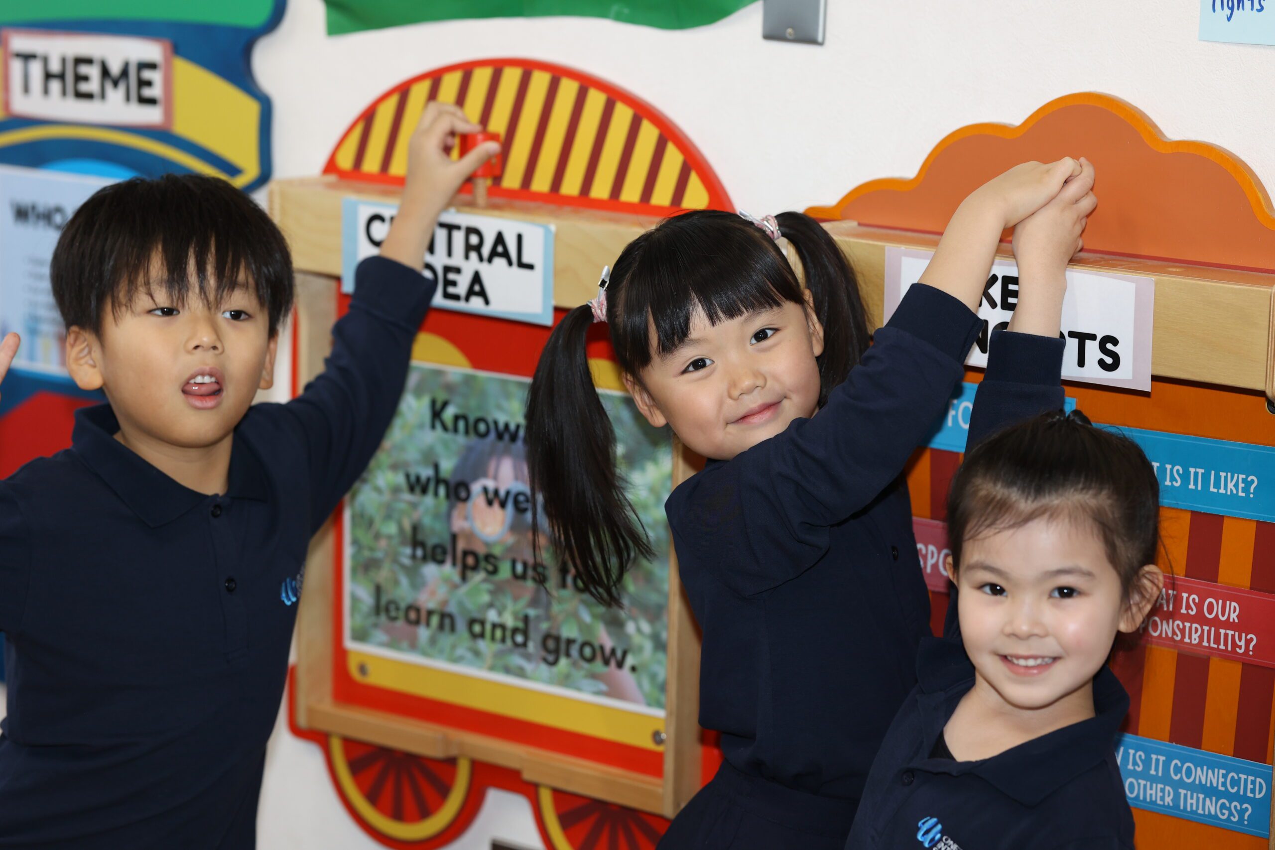 Early Childhood students at OWIS Osaka play with a mounted train on the wall, and, IB information can be seen on the walls of the classroom